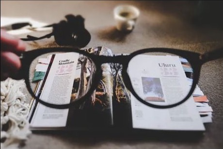 Books and glasses representing research and innovation