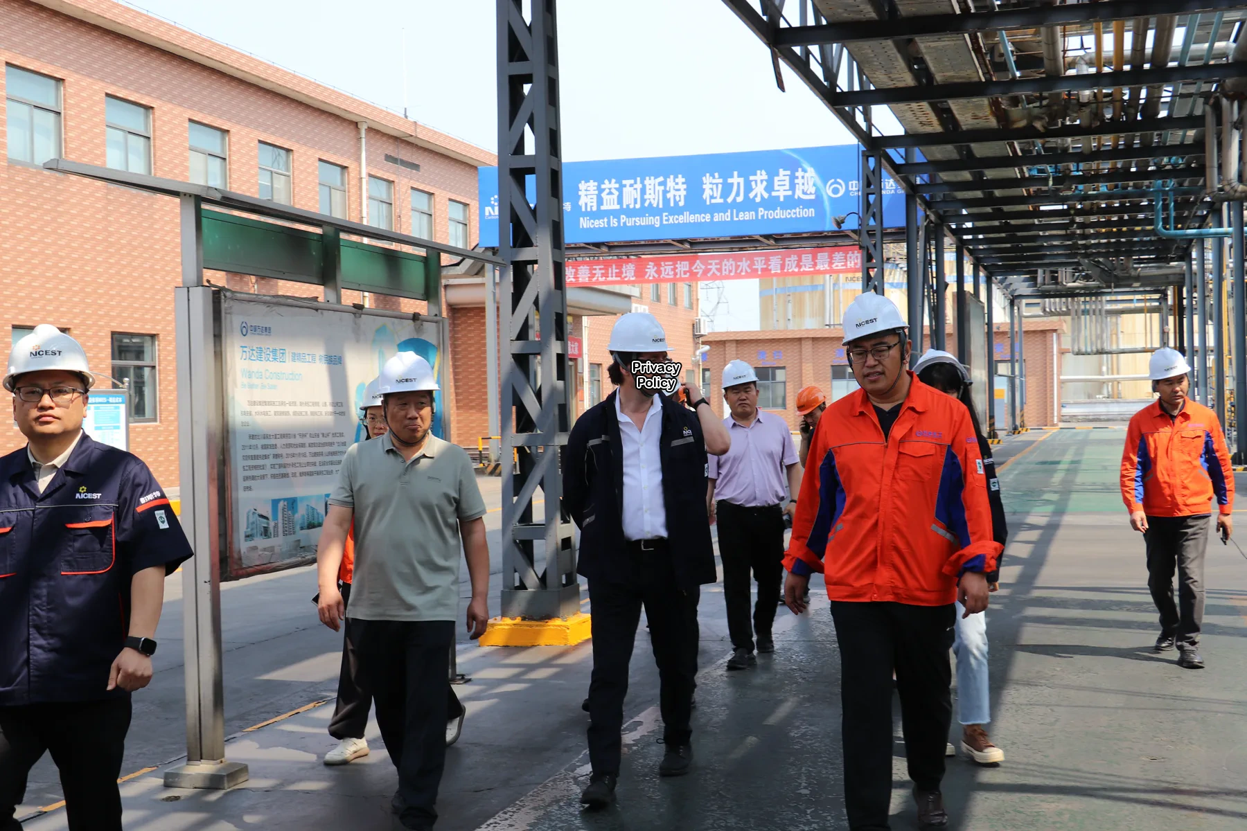 Expert walking through an advanced materials project site with the local team